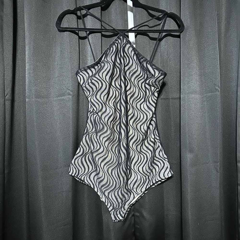 Black and nude mesh detailed body suit, snap buttons on bottom